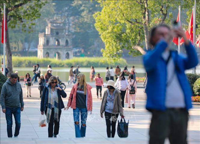 Foreign tourists take strolls in Hanoi's Hoan Kiem Lake area. VNA Photo