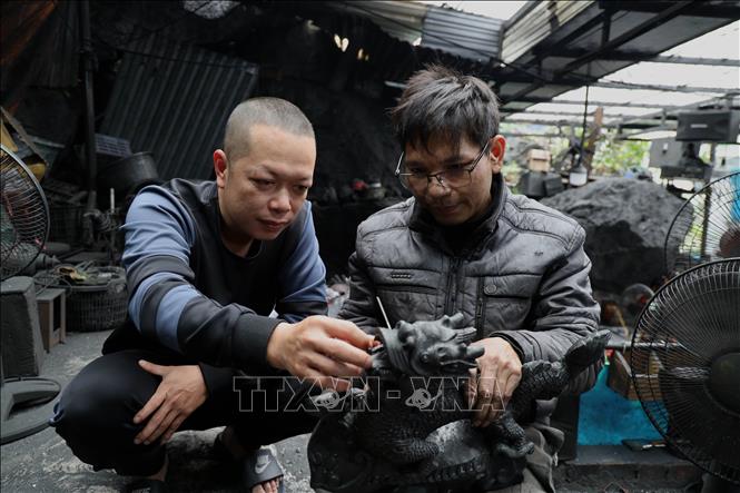Trao đổi hoàn thiện sản phẩm. Ảnh: Đức Hiếu - TTXVN