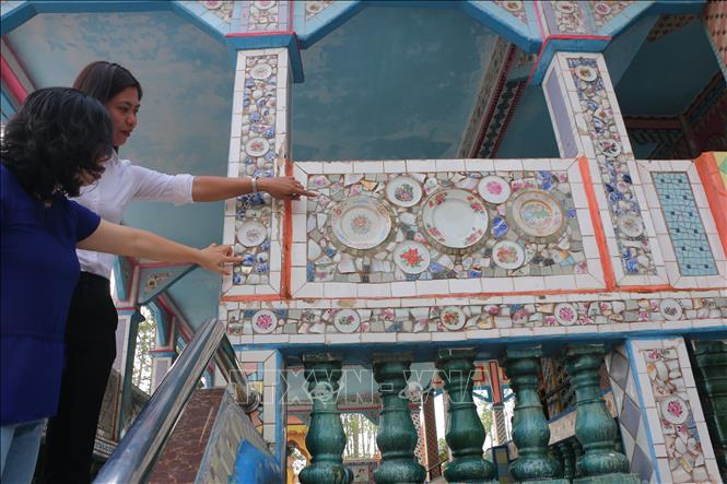 Các mảnh chén, dĩa sứ kiểu được ốp trang trí trên tường, cột của chánh điện chùa Sà Lôn. Ảnh: Minh Hưng – TTXVN