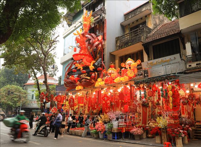 Một cửa hàng trên phố Hàng Mã làm mô hình rồng đỏ cao 12m nhân dịp Tết Giáp Thìn. Ảnh: Hoàng Hiếu - TTXVN