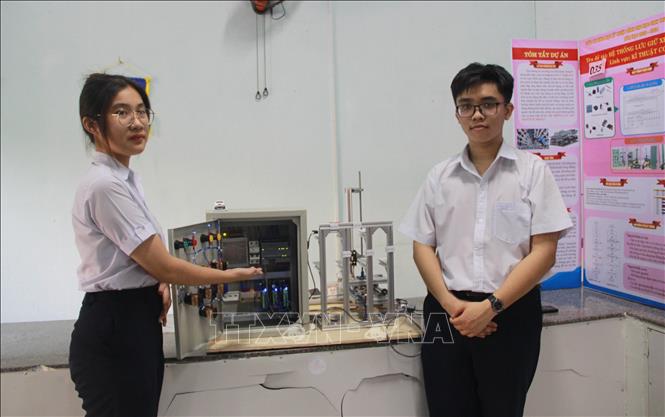 Em Nguyễn Ngọc Quỳnh Trâm (lớp 11) và Vân Duy Kỳ (lớp 10) Trường Trung học phổ thông Nguyễn Thiện Thuật thuyết trình mô hình “Hệ thống lưu giữ xe ô tô tự động”. Ảnh: Phan Sáu - TTXVN