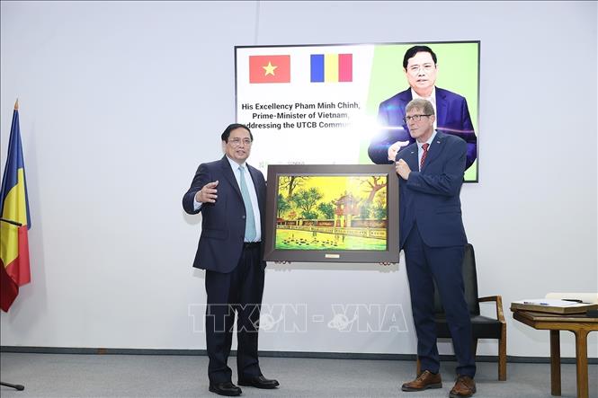 Prime Minister Pham Minh Chinh presents a painting of Van Mieu - Quoc Tu Giam (The Temple of Literature) to leaders of the Technical University of Civil Engineering of Bucharest. VNA Photo: Dương Giang