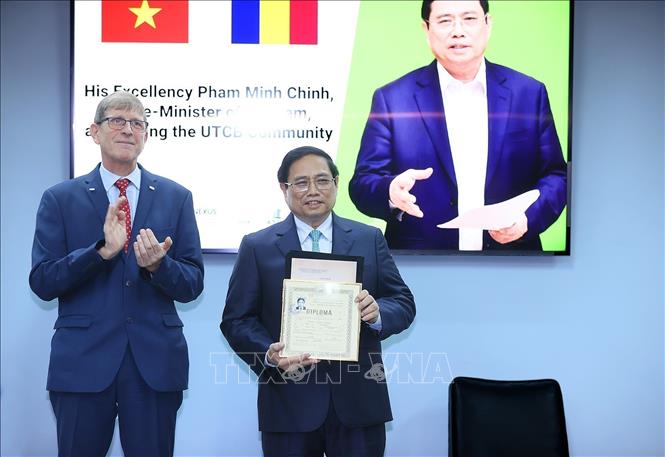 Prime Minister Pham Minh Chinh receives his student's profile from the time he was studying at the university. VNA Photo: Dương Giang