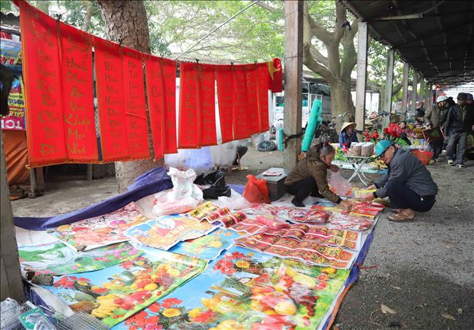 Gian hàng bày bán câu đối, tranh ảnh ngày Tết. Ảnh: Xuân Tiến - TTXVN 