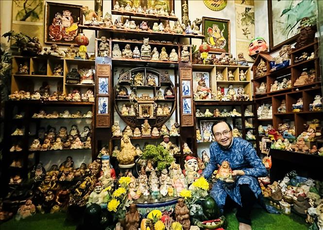 Researcher Nguyen Hieu Tin next to his Earth God collection of more than 400 statues. VNA Photo: Hồng Đạt