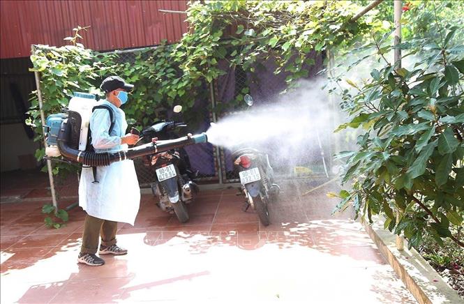 Spraying anti-mosquito chemicals at a village in northern Ha Nam province. VNA Photo