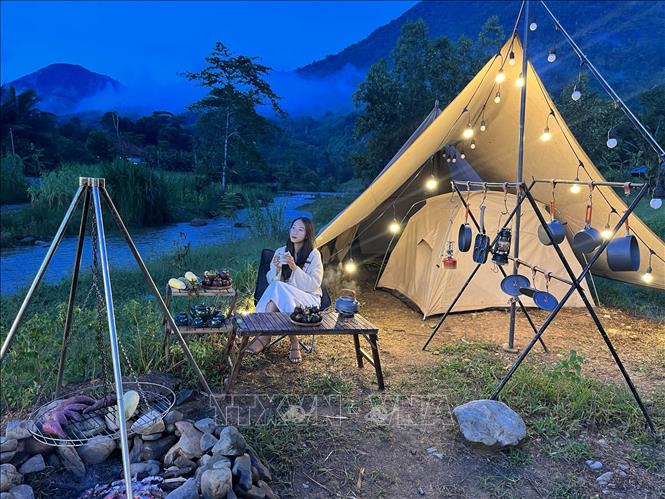 Trưởng nhóm Phương Trinh và khu vực cắm trại của dự án Khanh Son Eco. Ảnh: TTXVN phát