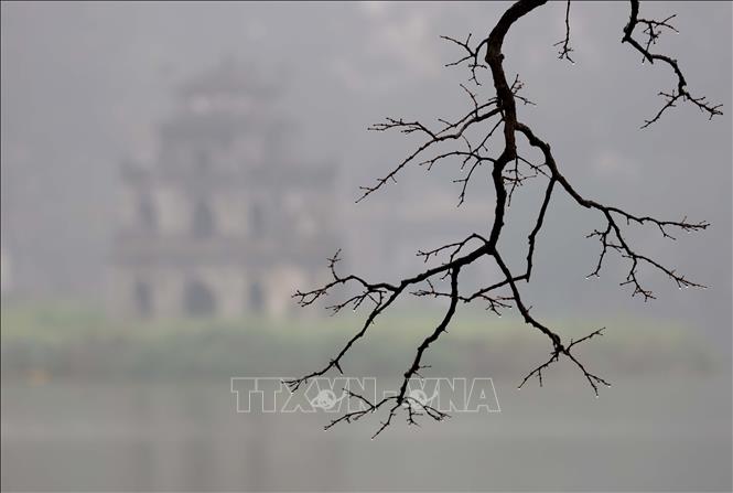 Màn sương bao phủ, tháp Rùa ẩn hiện trên mặt nước phẳng lặng càng tôn thêm vẻ đẹp cổ kính. Ảnh: Nhật Anh - TTXVN