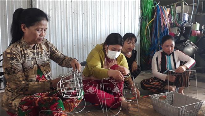 Lao động nữ ở nông thôn sau khi học nghề, nhận đan gia công cho cơ sở đan đát của chị Nguyễn Ngọc Diễm có thu nhập từ 3 – 4.000.000 đồng/tháng. Ảnh: TTXVN phát