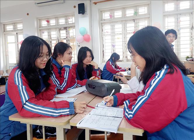 Hà Linh cùng các bạn trong đội tuyển thi học sinh giỏi tiếng Trung trau dồi kỹ năng nghe  tiếng Trung. Ảnh: Thanh Vân-TTXVN