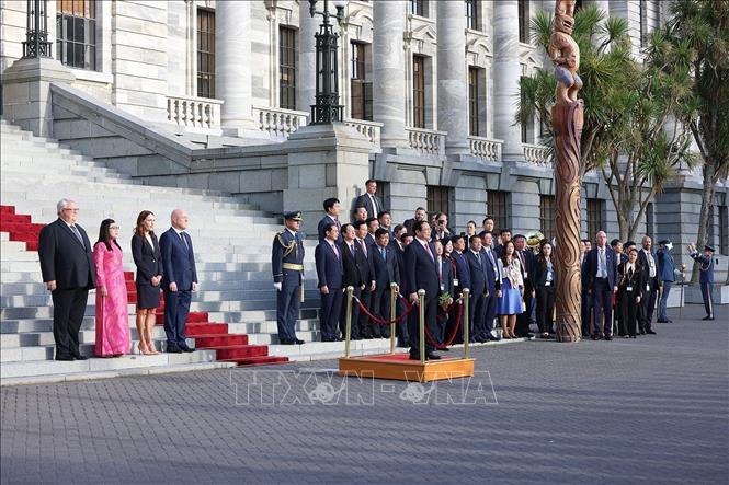 Vietnamese Prime Minister Pham Minh Chinh listens to the national anthems of Vietnam and New Zealand. VNA Photo: Dương Giang