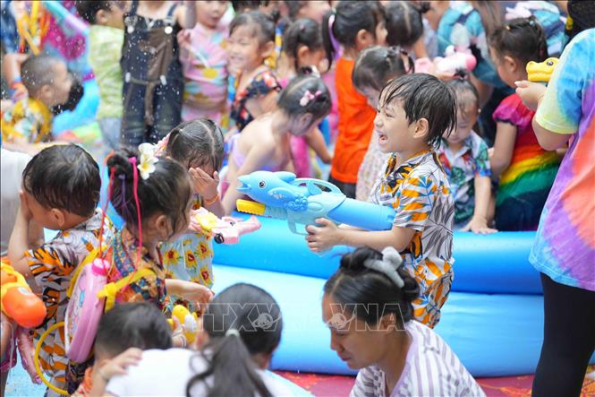 Các em nhỏ cùng nhau chơi té nước. Ảnh: Đỗ Bá Thành-PV TTXVN tại Lào
