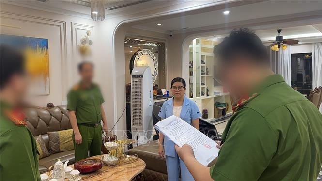 Cơ quan Công an tống đạt các quyết định tố tụng. Ảnh TTXVN phát