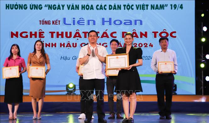 Trao bằng khen của Chủ tịch UBND tỉnh cho đại diện đơn vị huyện Long Mỹ. Ảnh: Hồng Thái - TTXVN