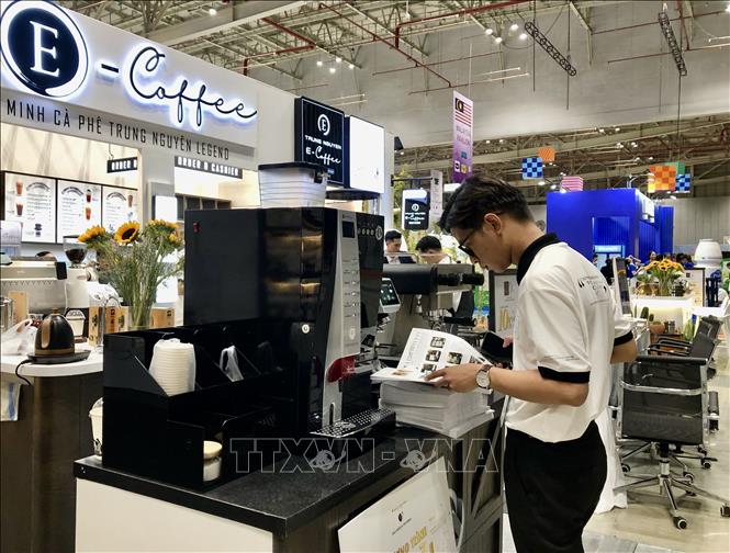 An exhibition stall decorated in a coffee shop style at the event. VNA Photo: Mỹ Phương