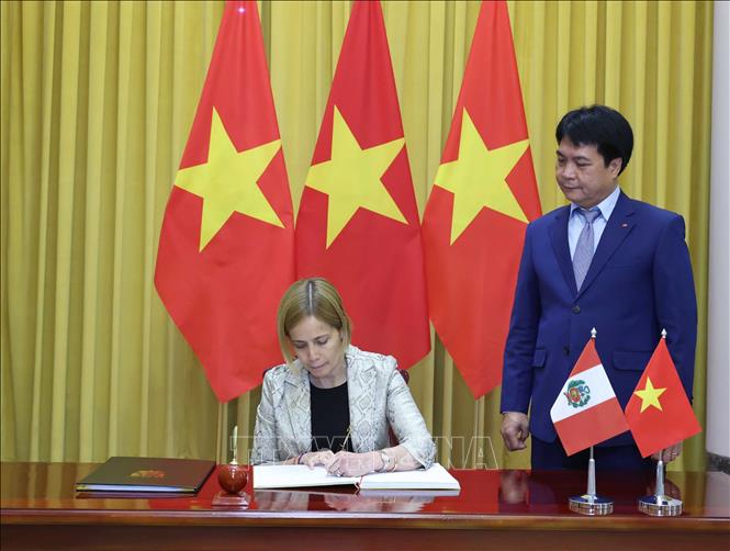 Đại sứ Peru Patricia Yolanda Raez Portocarrrero ký lưu bút. Ảnh: Thống Nhất – TTXVN
