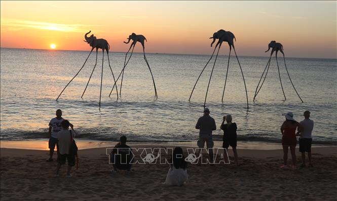 Tourists enjoy sunset on Bai Truong beach. VNA Photo