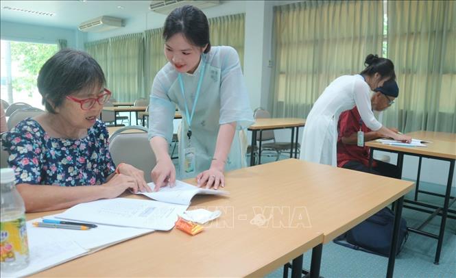 Các cô giáo tận tình chỉ dẫn học viên làm quen với tiếng Việt. Ảnh: TTXVN phát 

