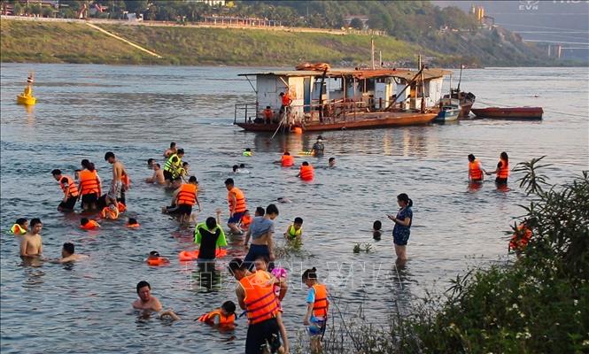  Cứ vào khoảng 5h30 - 7h và 16 - 18h30h hàng ngày, người dân 2 bên bờ sông Đà nô nức xuống sông tắm mát. Ảnh: Trọng Đạt-TTXVN