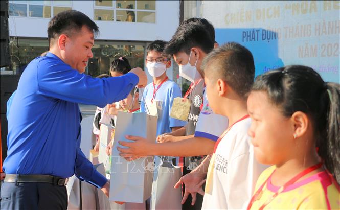 Bí thư Tỉnh đoàn An Giang Phan Duy Bằng tặng quà cho thiếu nhi có hoàn cảnh đặc biệt khó khăn trên địa bàn thành phố Long Xuyên. Ảnh: Công Mạo - TTXVN