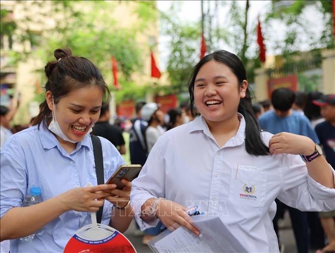 Phụ huynh đón thí sinh sau khi hoàn thành môn thi đầu tiên tại điểm thi Trường THPT Trần Nhân Tông, quận Hai Bà Trưng. Ảnh: Thanh Tùng - TTXVN 
