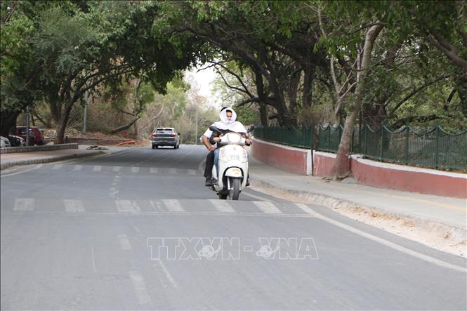 Người dân trùm kín khi di chuyển dưới trời nắng nóng hơn 50 độ C ở New Delhi. Ảnh: Ngọc Thúy - Pv TTXVN tại Ấn Độ