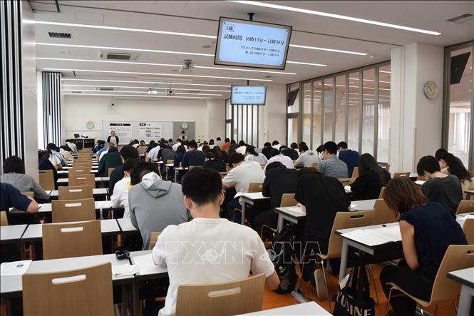 Candidates focus on the Vietnamese writing test. VNA Photo