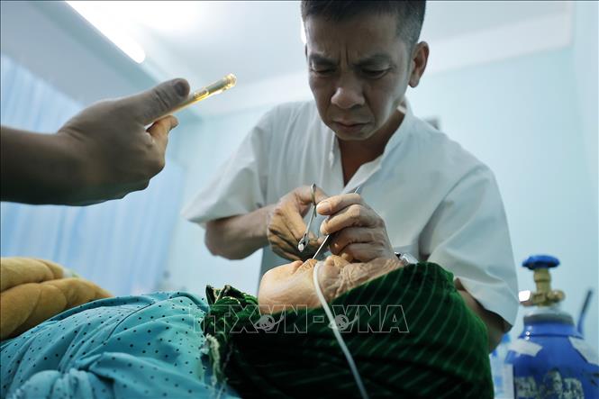 Bác sĩ Đông cùng ê kíp cấp cứu cho một bệnh nhân. Ảnh: Minh Quyết – TTXVN