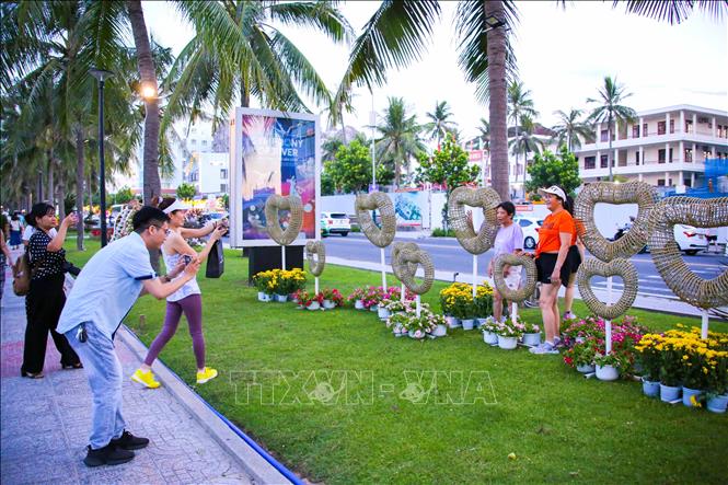 Người dân, du khách thích thú dạo chơi chụp ảnh trên “Đường hoa biển Đà Nẵng 2024” vừa khai trương. Ảnh: Trần Lê Lâm - TTXVN 