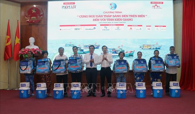 Lãnh đạo tỉnh Kiên Giang và báo Pháp Luật Thành phố Hồ Chí Minh tặng quà cho ngư dân huyện Châu Thành (Kiên Giang). Ảnh: Lê Huy Hải - TTXVN