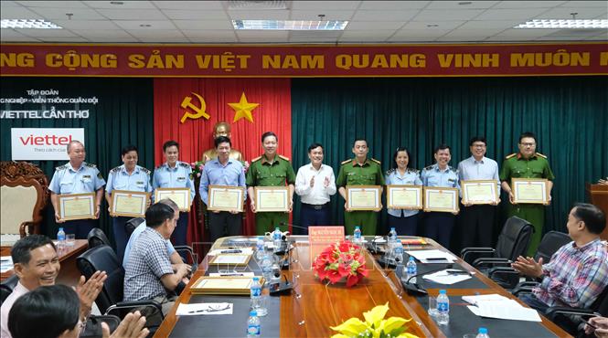 Trao Bằng khen của Chủ tịch UBND TP Cần Thơ cho các cá nhân có thành tích xuất sắc trong công tác phòng chống buôn lậu, gian lận thương mại và hàng giả. Ảnh: Thanh Liêm - TTXVN
