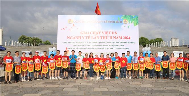 Ban Tổ chức tặng cờ lưu niệm cho các đơn vị tham gia giải. Ảnh: Thùy Dung - TTXVN