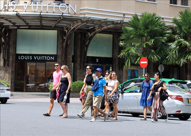 Tourists walk on Dong Khoi street, District 1, Ho Chi Minh city to discover the special cultural and historical values of the southern city. VNA Photo: Hồng Đạt