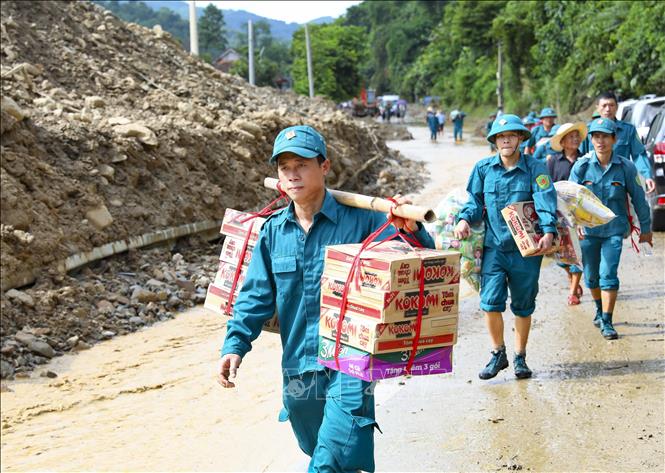 Các lực lượng tham gia vận chuyển đồ cứu trợ cho người dân vùng lũ. Ảnh: Xuân Tư - TTXVN