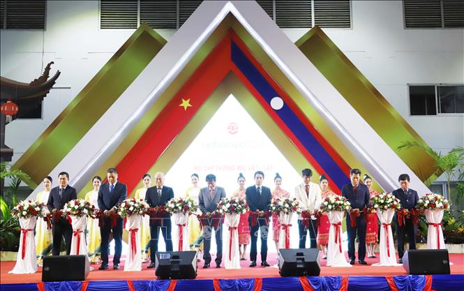 Đại sứ Việt Nam tại Lào Nguyễn Bá Hùng và các đại biểu cắt băng khai mạc triển lãm. Ảnh: Xuân Tú - PV TTXVN tại Lào