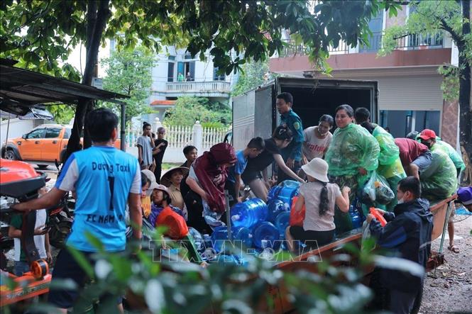 Chuẩn bị đồ tiếp tế cho người dân làng Nam Hài đang bị cô lập do ngập. Ảnh: Hoàng Hiếu - TTXVN