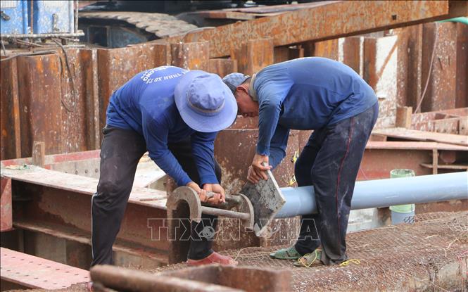 Công nhân đẩy nhanh tiến độ thi công trên công trường. Ảnh: Tuấn Phi-TTXVN