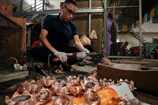 Sản phẩm sau khi đúc xong được người thợ làm bóng, hoàn thiện thủ công qua các công đoạn. Ảnh: Minh Quyết - TTXVN