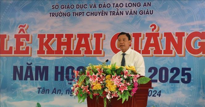 Phó Chủ tịch UBND tỉnh Long An Phạm Tấn Hòa công bố Quyết định đổi tên trường THPT Chuyên Long An thành Trường THPT Chuyên Trần Văn Giàu. Ảnh: Thanh Bình-TTXVN 