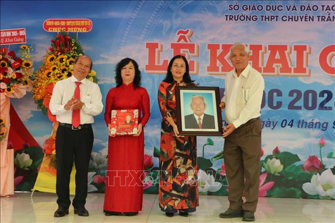 Trưởng Ban Tuyên giáo Tỉnh ủy Long An Hoàng Đình Cán (ngoài cùng bên trái) tặng tập sách của Giáo sư Trần Văn Giàu cho Ban Giám hiệu trường THPT chuyên Trần Văn Giàu. Ảnh: Thanh Bình-TTXVN