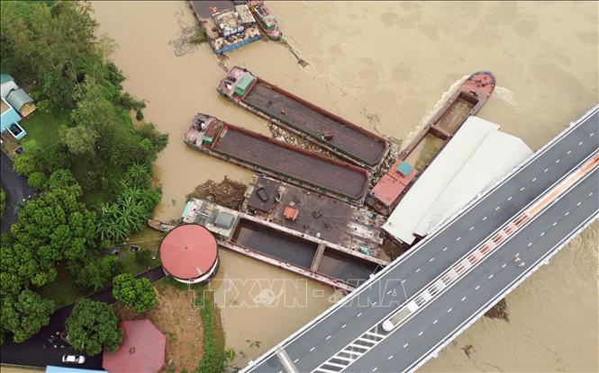 Hiện có 5 tàu chở hàng và một số sà lan bị mắc kẹt dưới chân cầu Vĩnh Phú thuộc địa bàn phường Dữu Lâu, thành phố Việt Trì (Phú Thọ) sáng 10/9/2024. Ảnh: Tạ Toàn - TTXVN