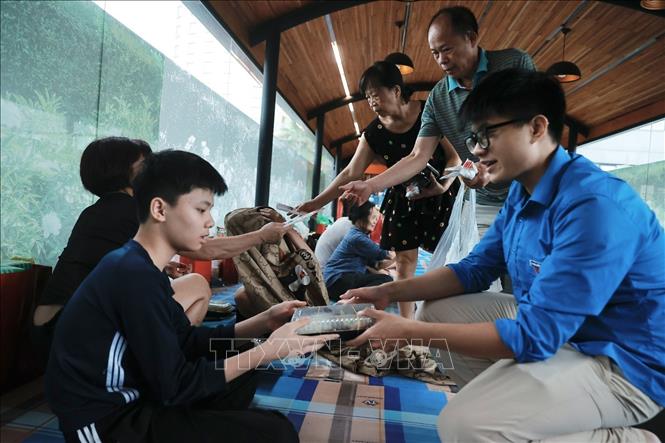 Các lực lượng phường Chương Dương hỗ trợ người dân nơi tránh lũ. Ảnh: Minh Quyết - TTXVN