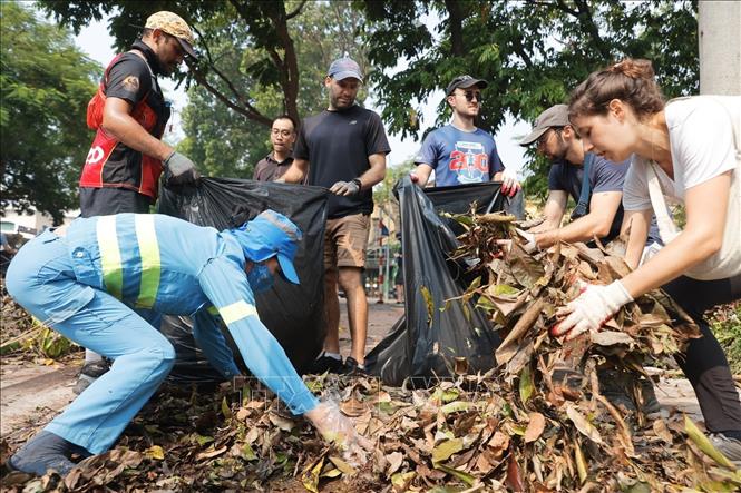 Cùng chung tay dọn dẹp, vệ sinh môi trường, khắc phục hậu quả bão số 3. Ảnh: Minh Quyết - TTXVN
