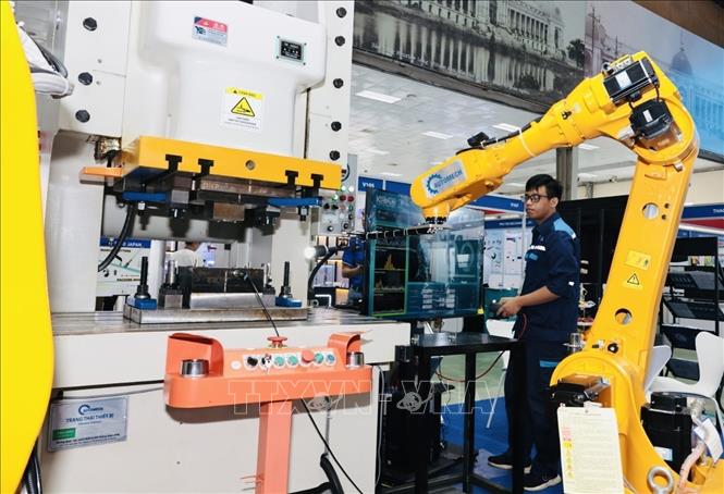 Gian trưng bày, giới thiệu robot tích hợp máy đột dập đến từ Trung Quốc. Ảnh: Trần Việt - TTXVN 