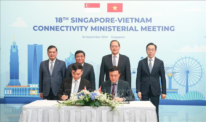 Signing a Memorandum of Understanding between the Enterprise Singapore and the Foreign Investment Agency under the Vietnamese Ministry of Planning and Investment. VNA Photo: Lê Dương