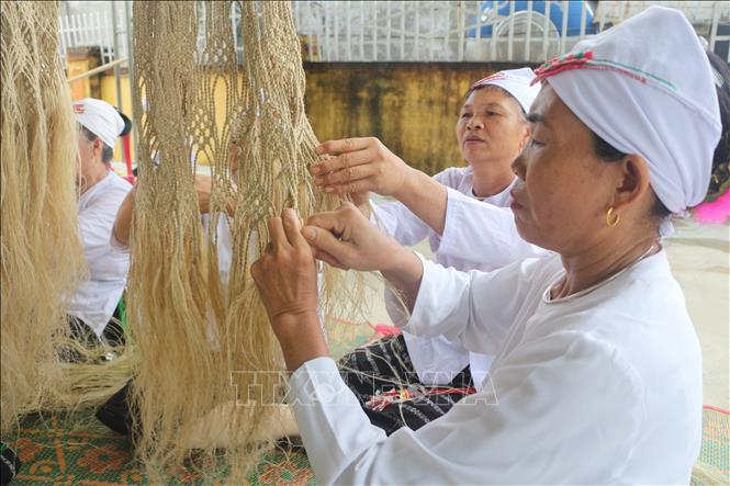 Phụ nữ dân tộc Thổ đan võng gai. Ảnh: Bích Huệ - TTXVN