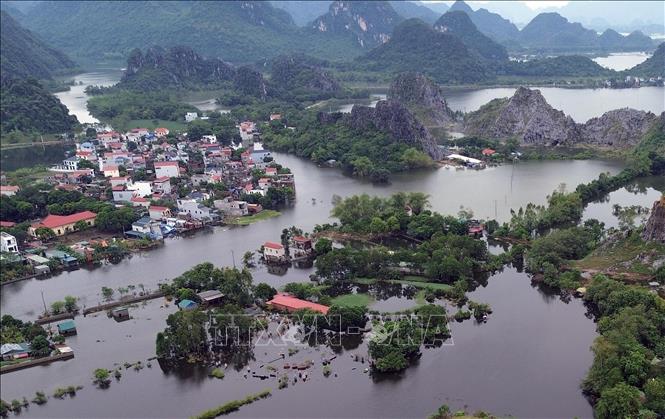Nhiều hộ dân ở thôn Đồng Chiêm, xã An Phú vẫn đang ngập sâu trong biển nước. Ảnh: Trần Việt - TTXVN