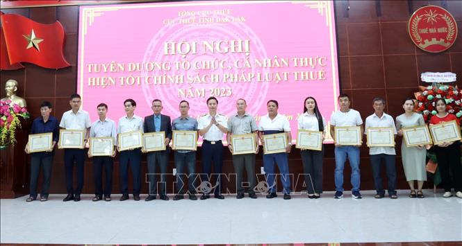 Cục Thuế tỉnh Đắk Lắk tặng Giấy khen cho các hộ gia đình, cá nhân thực hiện tốt chính sách, pháp luật thuế năm 2023. Ảnh: Hoài Thu - TTXVN