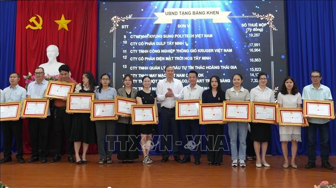 Tặng Bằng khen của Chủ tịch UBND tỉnh Tây Ninh cho doanh nghiệp, người nộp thuế thực hiện tốt chính sách, pháp luật thuế năm 2023. Ảnh: Minh Phú - TTXVN