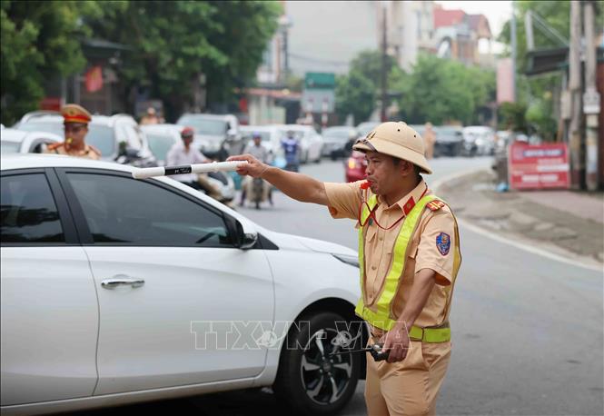 Lực lượng Cảnh sát giao thông tích cực phân luồng cho các hướng vào cầu phao Phong Châu. Ảnh: An Đăng - TTXVN